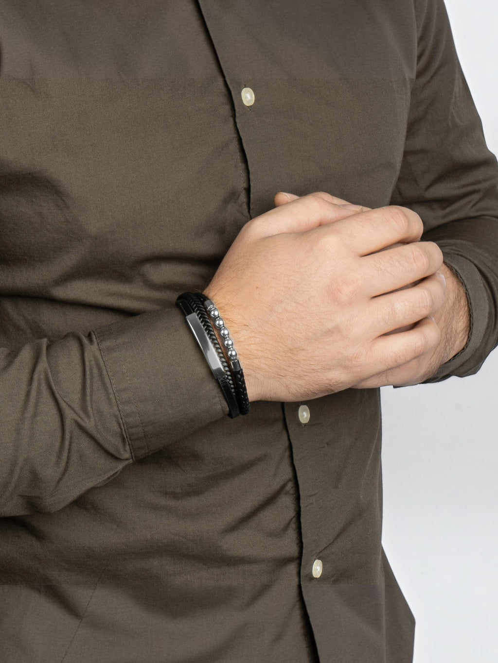 BROCK SERASAR Pearl silver and black leather bracelet with stainless steel magnetic clasp worn on a man's wrist