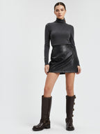 Model wearing BROCK STEPHAN PARIS brown leather biker boots with multi-buckle straps and block heels