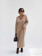 BROCK long beige striped maxi dress with V-neck and long sleeves worn by a woman with sunglasses and brown boots