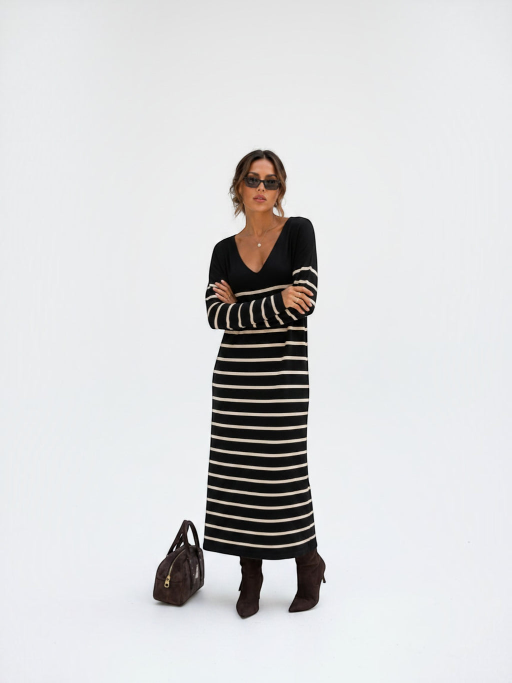 BROCK long striped maxi dress with V-neck and long sleeves worn by a model with sunglasses and brown boots