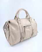 BROCK SYSTYLE beige synthetic weekend travel bag with braided handles, gold metal hardware, and front zip pocket.