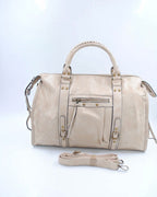 BROCK SYSTYLE beige synthetic weekend travel bag with braided handles, gold rivets, and adjustable shoulder strap.