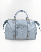 BROCK SYSTYLE light blue synthetic weekend travel bag with gold hardware, braided handles, and front zip pocket.