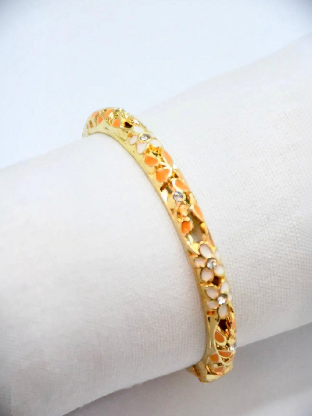 BROCK gold-tone brass Thai-inspired bangle bracelet with floral enamel details and sparkling crystal accents