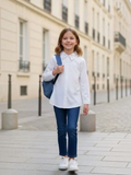 BROCK girl wearing a white cotton shirt with heart rhinestones on the collar, paired with blue jeans and sneakers.
