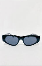 Lunettes de soleil ÉLINE L'ATELIER noires, monture épaisse et verres gris fumé, design géométrique audacieux.