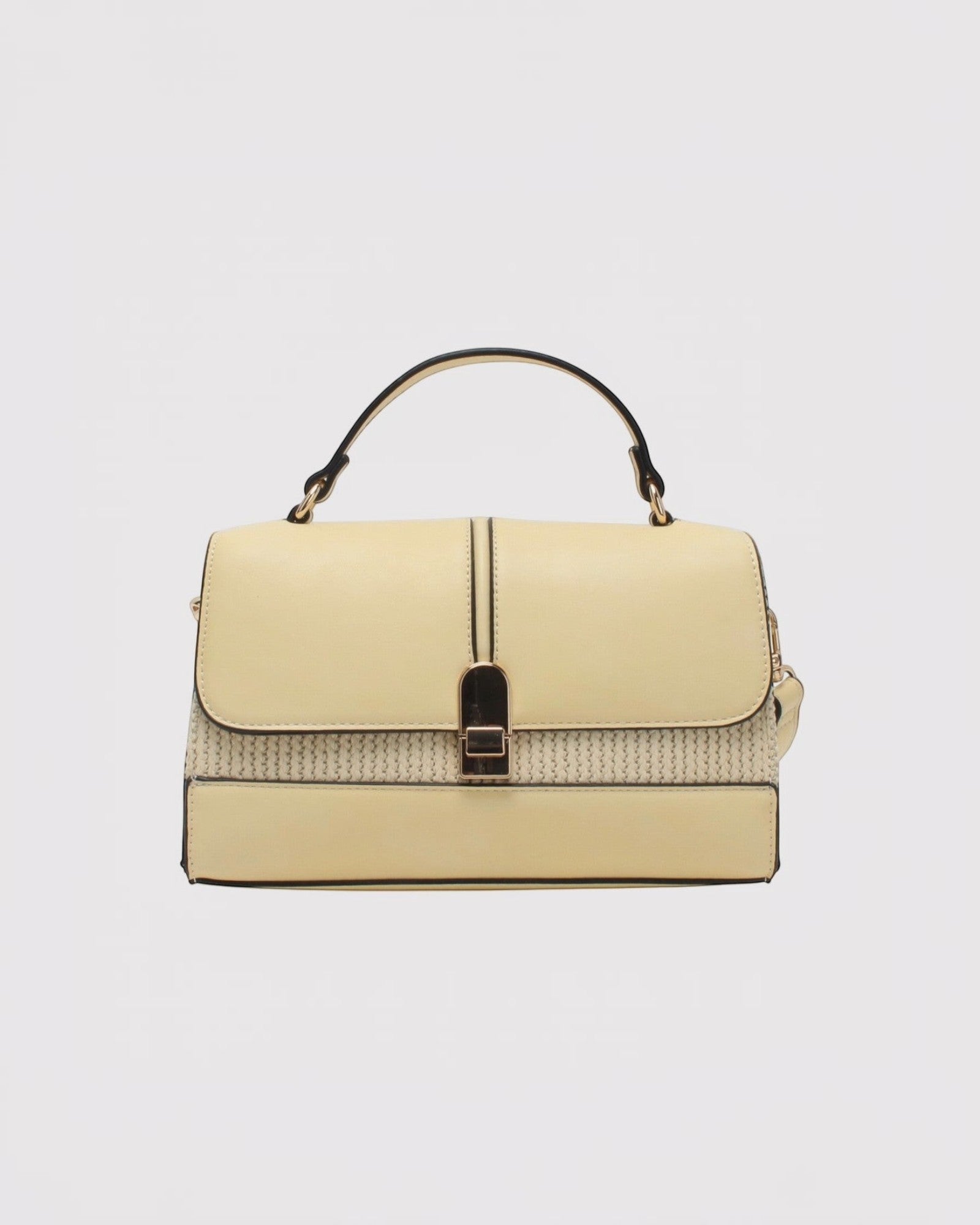 Sac bandoulière en cuir bi-matière jaune pâle avec fermoir à pression doré et anse supérieure.