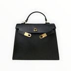 Sac à main noir en cuir véritable italien LOUISA LEE de BROCK avec fermoir doré et poignée supérieure.