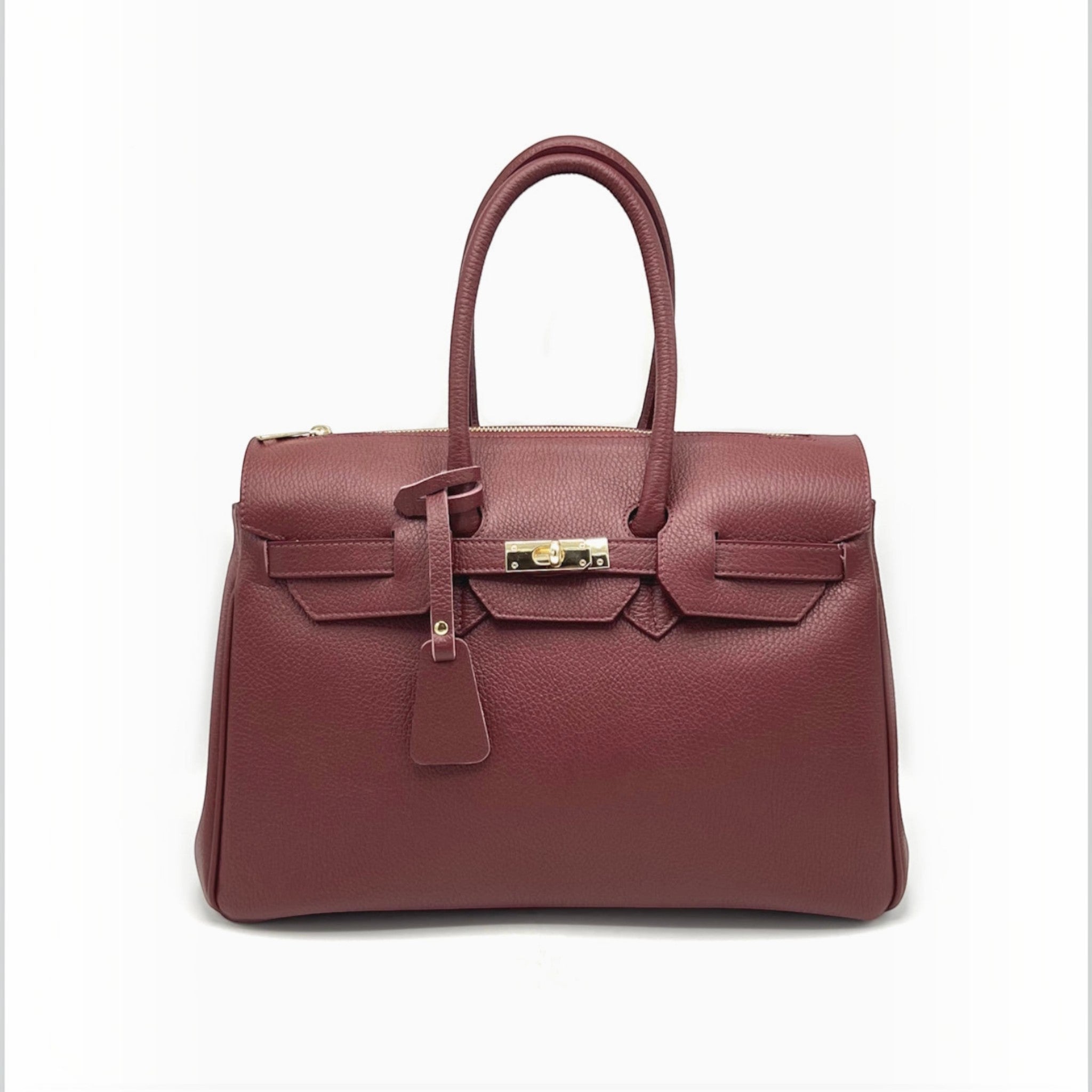 Grand sac à main professionnel  en cuir grainé bordeaux avec fermoir doré et poignées structurées.