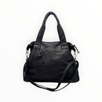 Sac à main en cuir noir avec anses tressées, fermeture zippée et bandoulière amovible réglable.