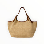 Sac à main  Louisa Lee en raphia tressé naturel et anses en cuir de vachette marron, style chic et artisanal.