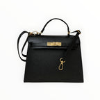 Sac Stella noir en cuir véritable italien LOUISA LEE de BROCK avec fermoir doré et bandoulière amovible.