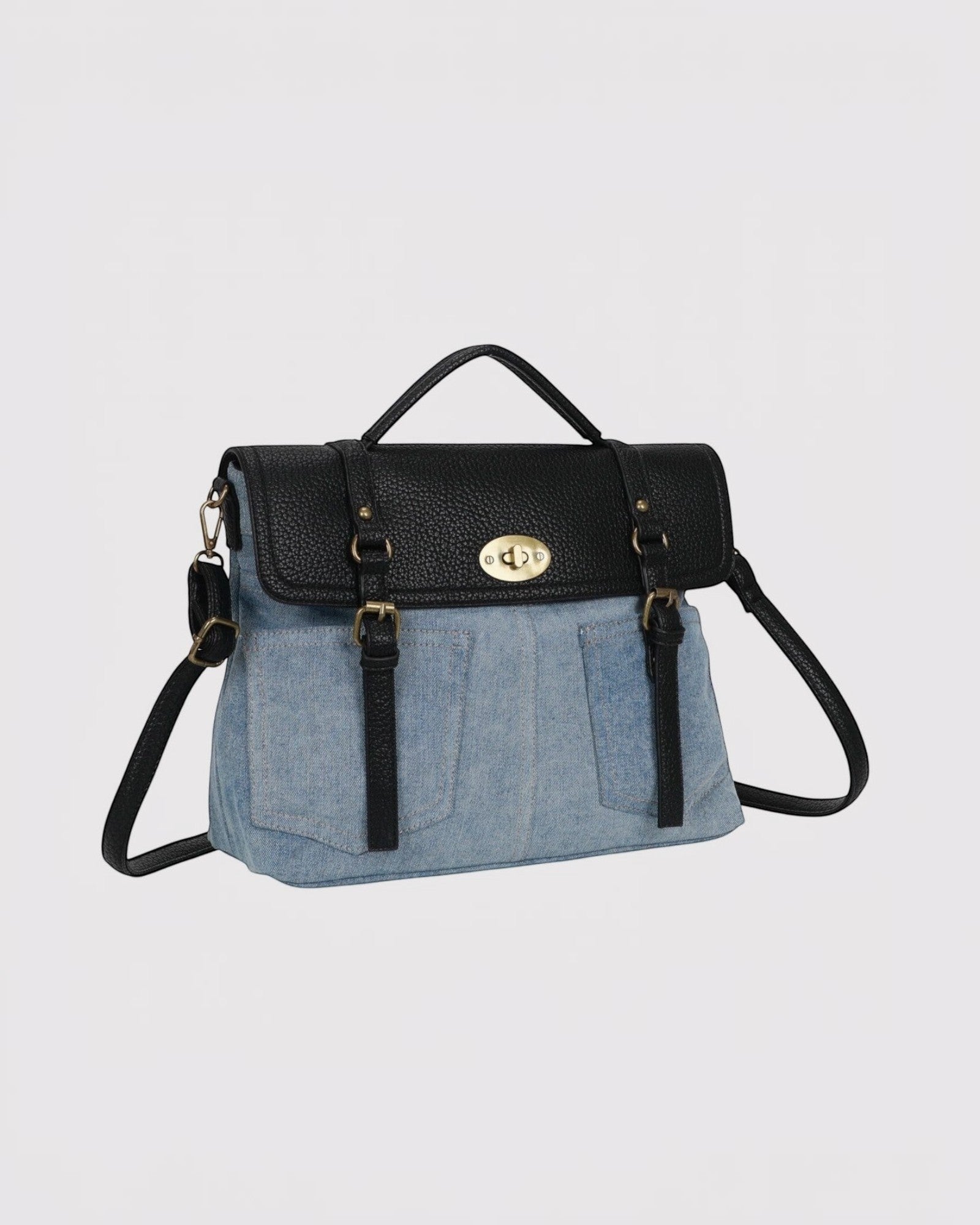 sacoche bandoulière en toile denim bleu clair et similicuir noir avec fermoir doré, style cartable vintage.